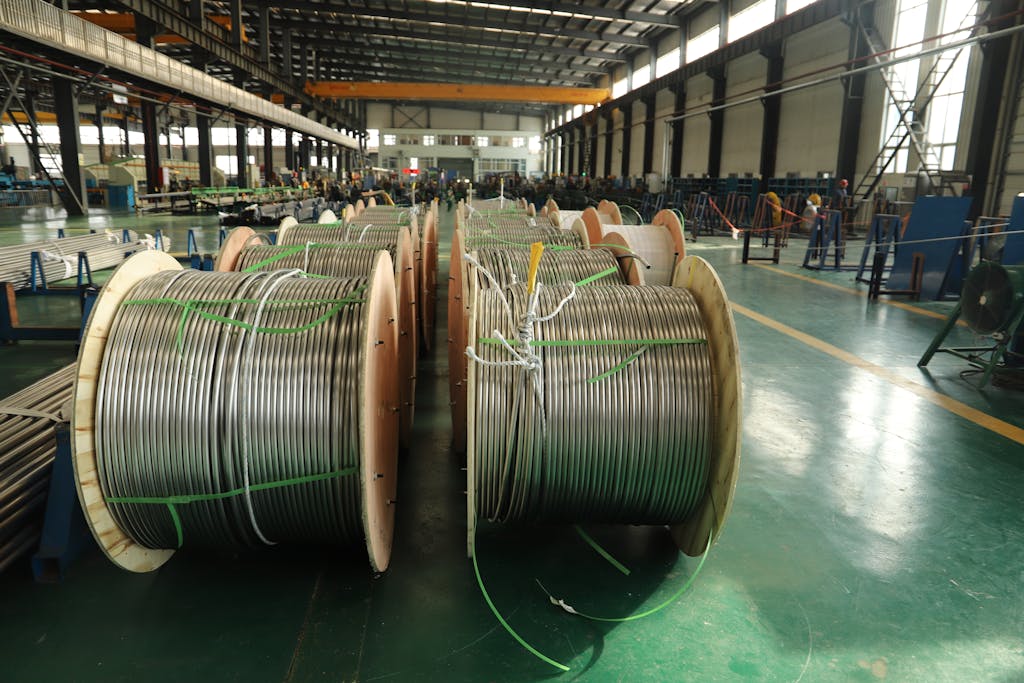 View of large cable reels in an industrial manufacturing facility, showcasing production scale.